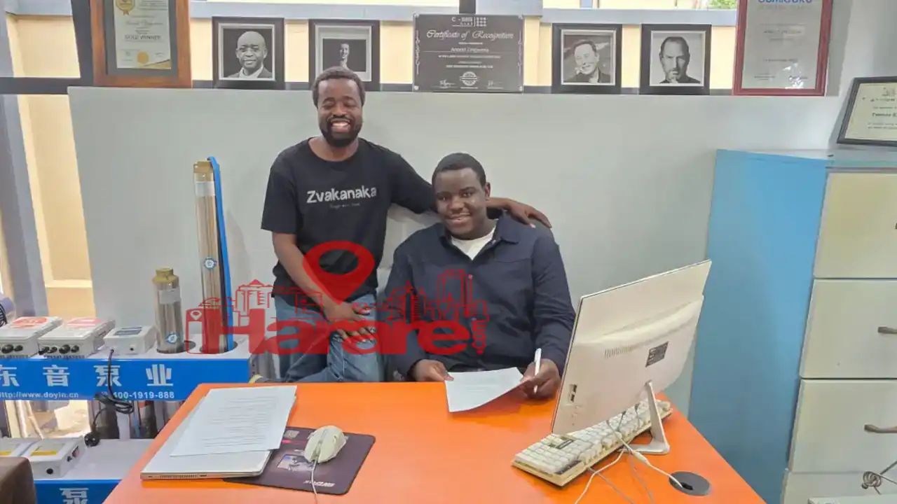 Arnold Zingwena of Tenga Solar and teenage inventor Darryl after signing a contract for a new solar-water hybrid battery.